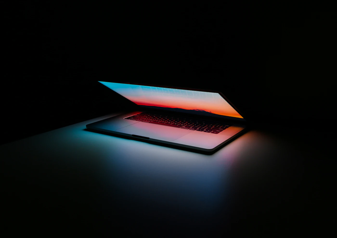 Laptop glowing in a dark room