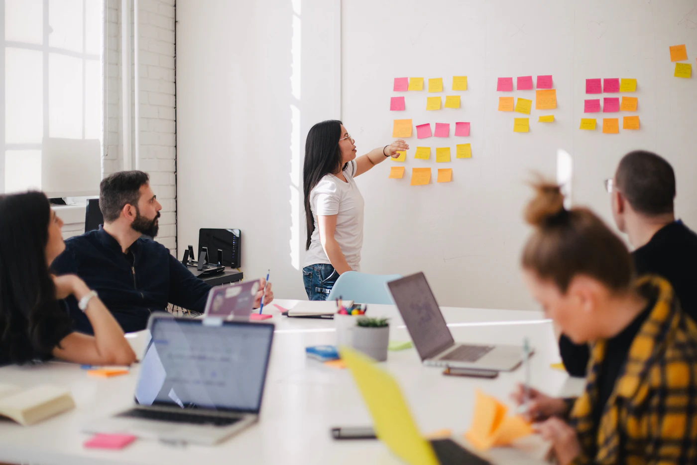 Team planning work together at a whiteboard